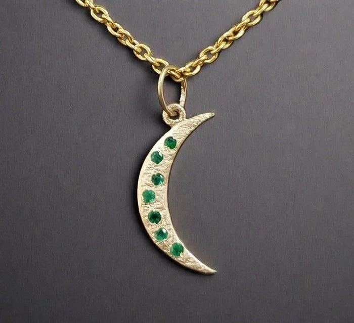 Gold crescent moon pendant necklace with emerald gemstones, elegant jewelry accessory