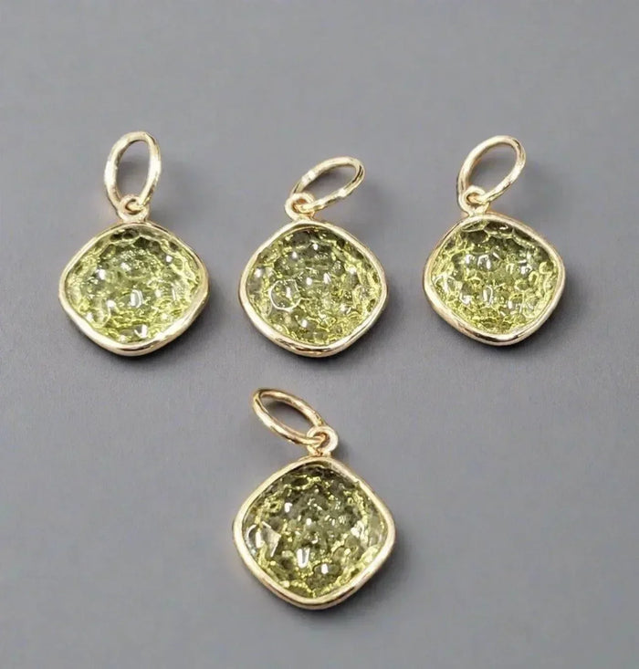 Four gold pendants with textured green gemstones, elegant jewelry accessories