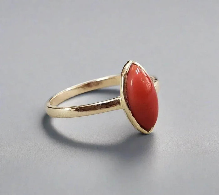 Elegant gold ring with marquise coral gemstone, luxury jewelry accessory