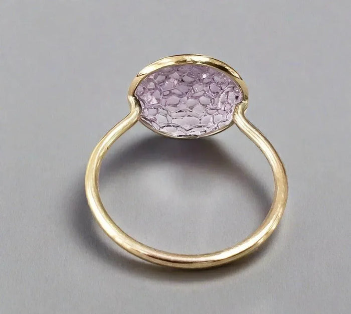 Elegant gold ring with oval lavender gemstone, sophisticated jewelry accessory