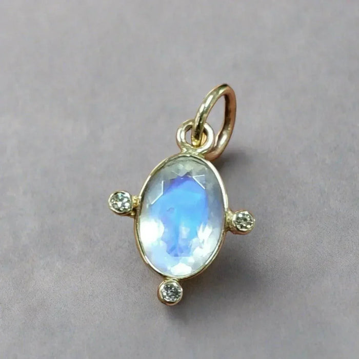 Elegant gold pendant with oval moonstone and diamond accents, perfect for sophisticated jewelry lovers