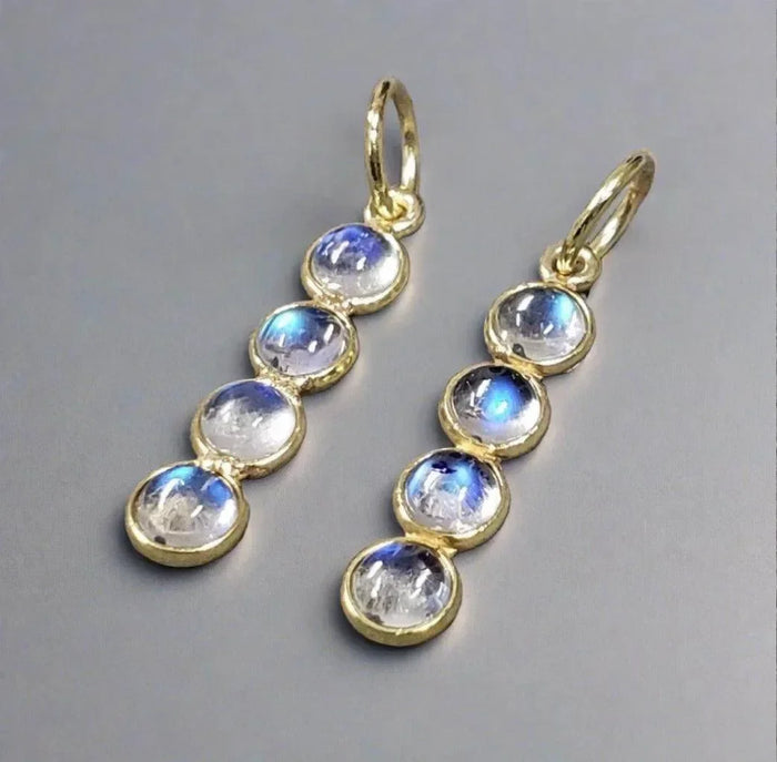 Elegant gold earrings with blue flash moonstones, perfect for sophisticated jewelry lovers