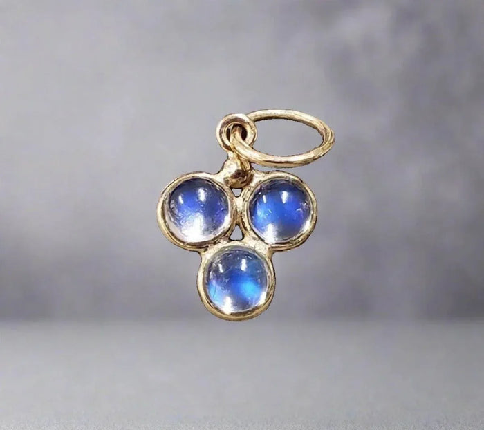Gold pendant with three blue gemstones, elegant jewelry accessory
