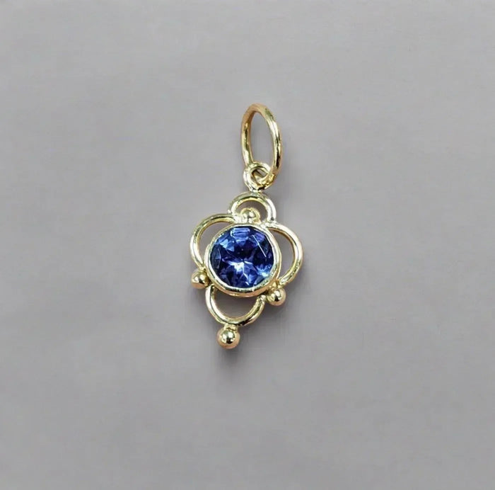 Gold pendant with blue gemstone, elegant jewelry accessory for necklaces