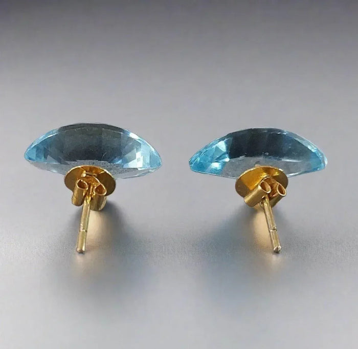 Elegant blue topaz stud earrings in gold setting, perfect for sophisticated jewelry lovers