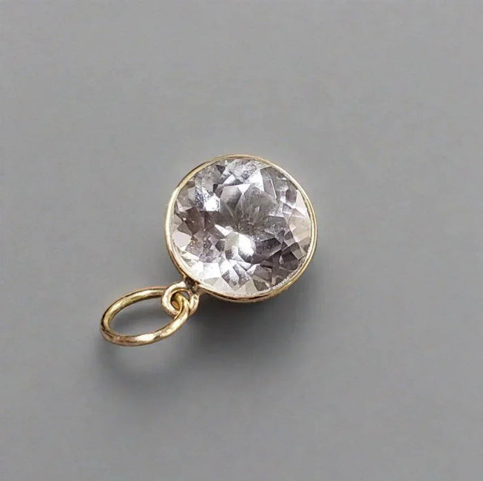 Elegant gold pendant with faceted clear gemstone, perfect for luxury jewelry collections