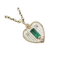 Heart-shaped gold pendant with emerald & diamonds on chain, elegant jewelry accessory