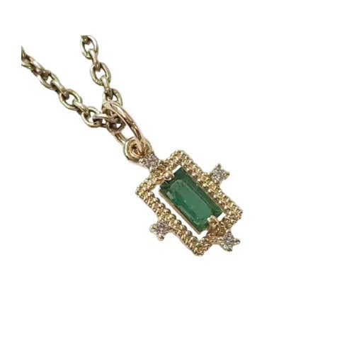 Elegant gold necklace with emerald and diamond accents, perfect for luxury jewelry lovers