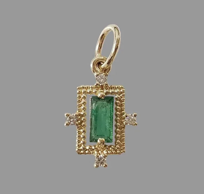 Elegant gold pendant with emerald center & diamond accents, luxury jewelry accessory