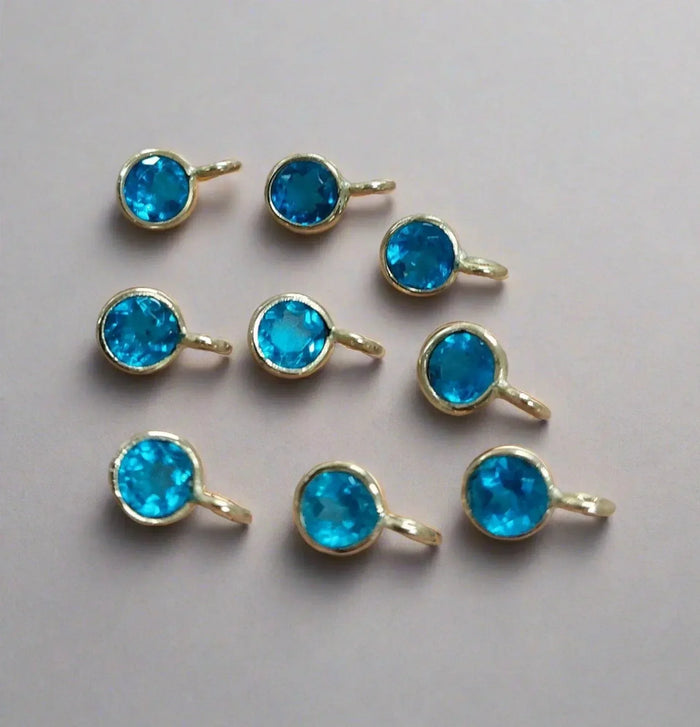 Gold bezel-set blue gemstone charms for elegant jewelry making
