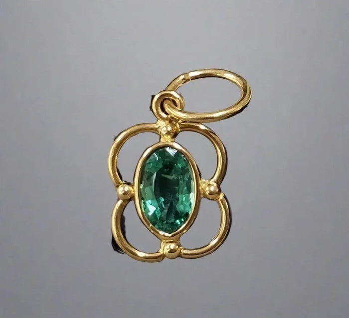 Elegant gold pendant with oval emerald, floral design, luxury jewelry accessory