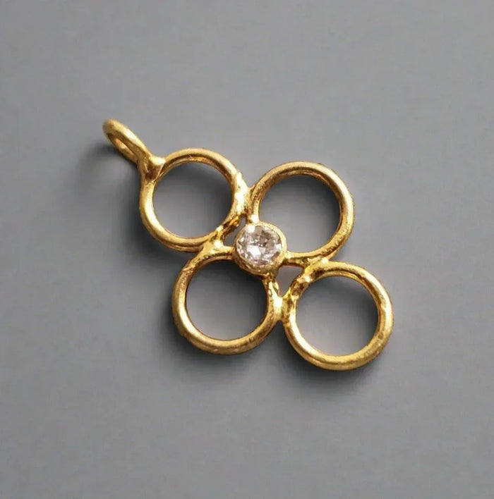 Gold flower pendant with diamond center, elegant jewelry accessory