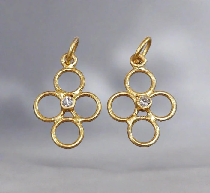 Gold flower-shaped earrings with diamond center, elegant jewelry accessory