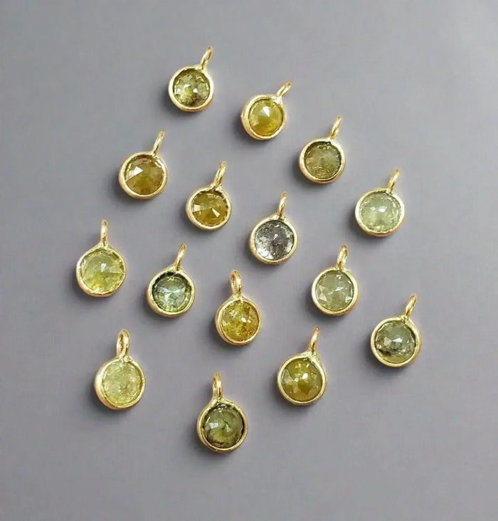 Gold bezel-set gemstone pendants in yellow, green, and gray hues for elegant jewelry making
