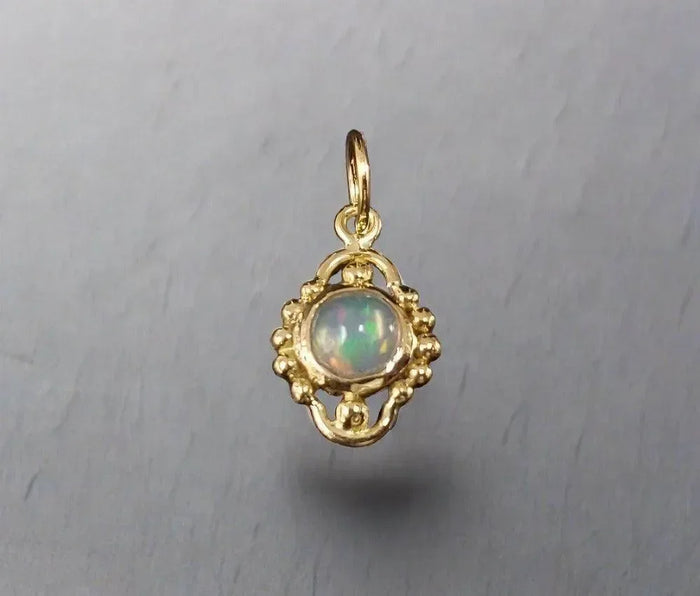 Elegant gold pendant with opal gemstone, vintage-inspired design for fine jewelry lovers