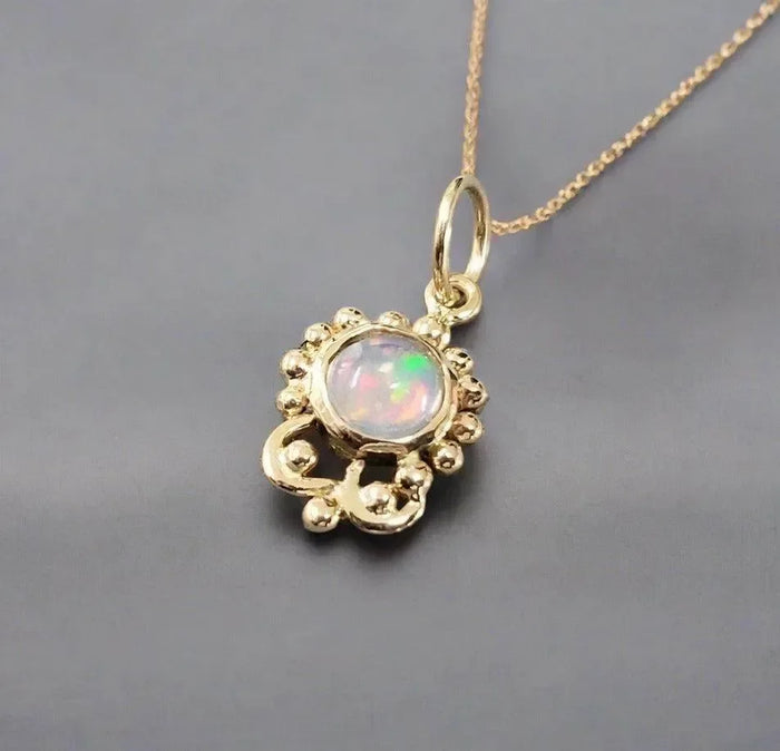 Elegant gold pendant with opal gemstone, delicate chain, luxury jewelry accessory