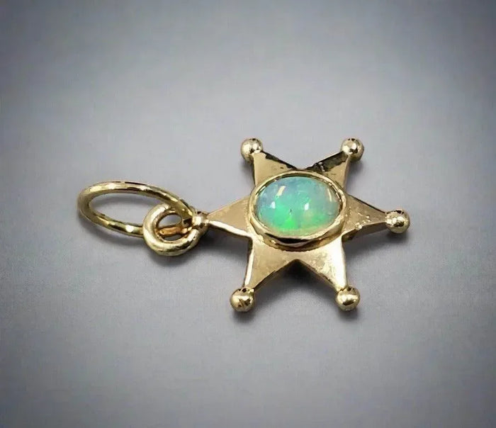 Gold star pendant with opal center, elegant jewelry accessory
