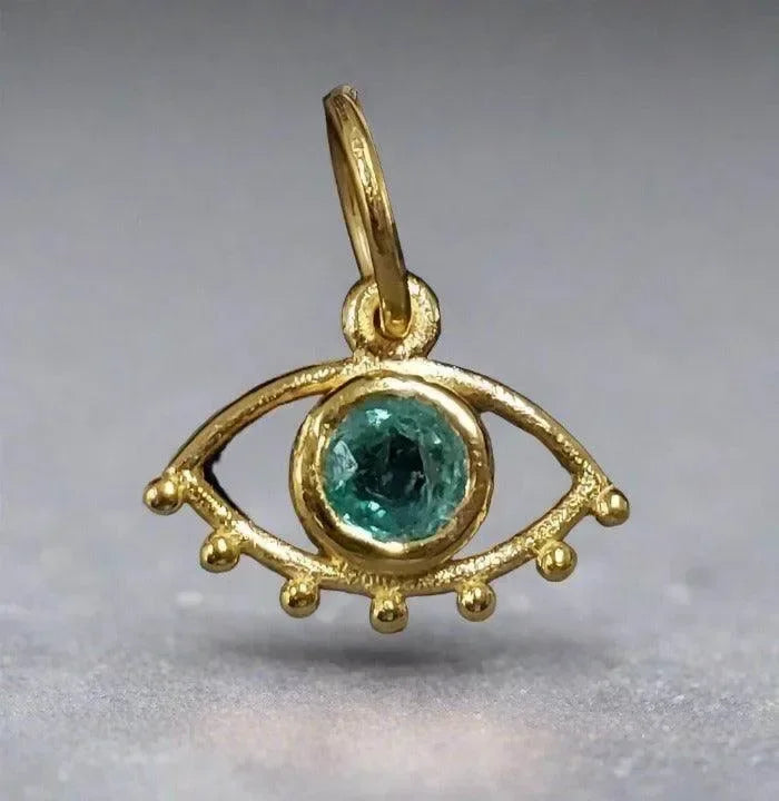 Gold evil eye pendant with green gemstone, elegant jewelry accessory