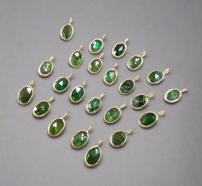 Oval green gemstone pendants in gold settings, elegant jewelry accessories