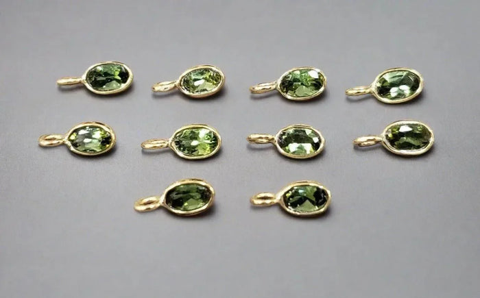 Gold oval pendants with green gemstones, elegant jewelry accessories