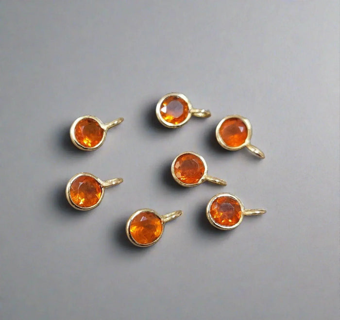 Gold citrine gemstone charms with faceted orange stones, elegant jewelry components