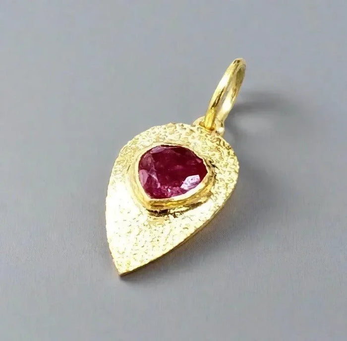 Gold leaf pendant with heart-shaped ruby, elegant jewelry accessory