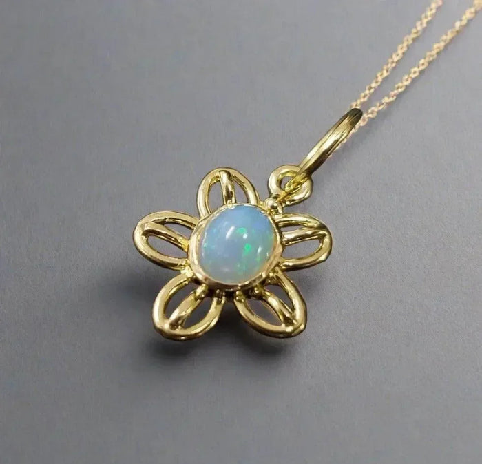 Gold flower pendant with opal gemstone, elegant jewelry accessory