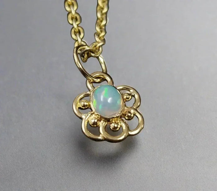 Elegant gold pendant with opal gemstone, floral design, perfect for luxury jewelry lovers