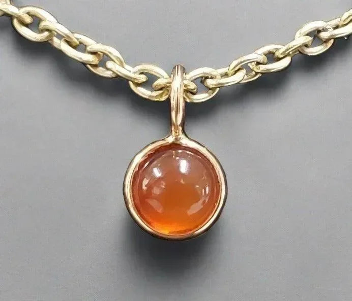 Gold chain necklace with round amber pendant, elegant jewelry accessory