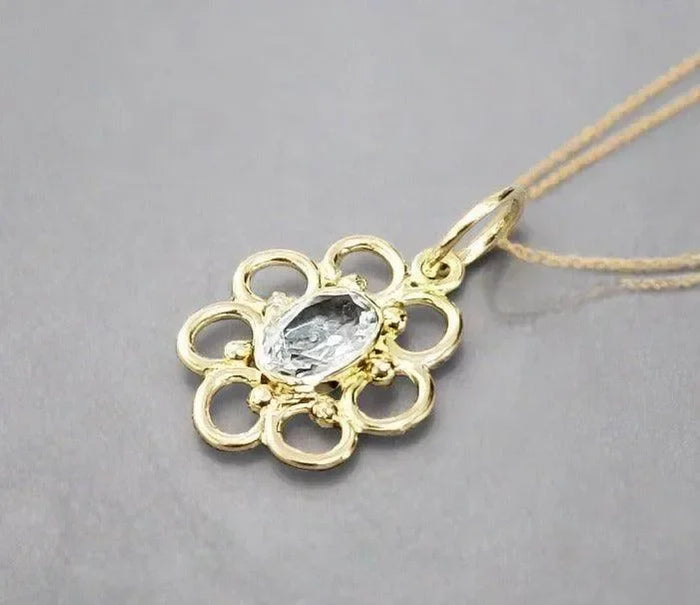 Elegant gold flower pendant with oval diamond, delicate chain, luxury jewelry accessory
