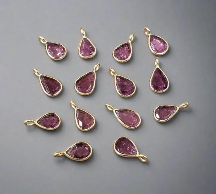 Teardrop pink gemstone pendants in gold settings, elegant jewelry accessories