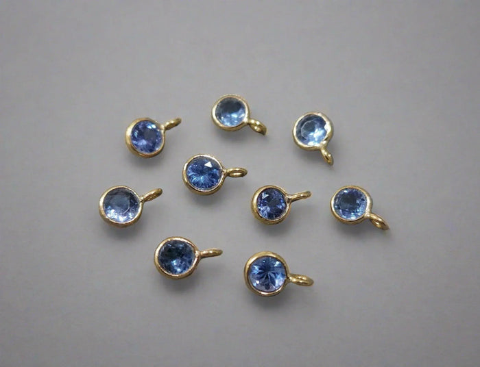 Gold bezel-set blue gemstone charms for elegant jewelry making