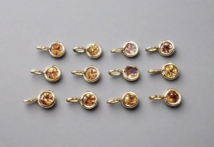 Gold charm pendants with round citrine gemstones, elegant jewelry accessories for necklaces or bracelets