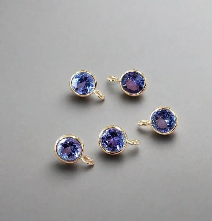 Five gold bezel-set tanzanite gemstone charms for elegant jewelry making