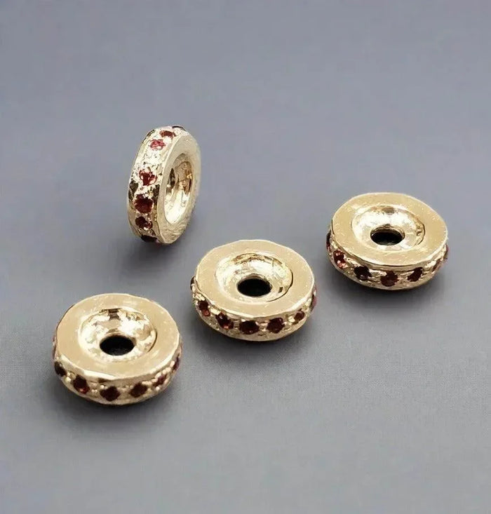 Gold-tone beads with red gem accents, ideal for elegant jewelry making and DIY accessories