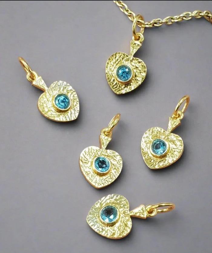 Gold heart pendants with blue gemstones, elegant jewelry accessories
