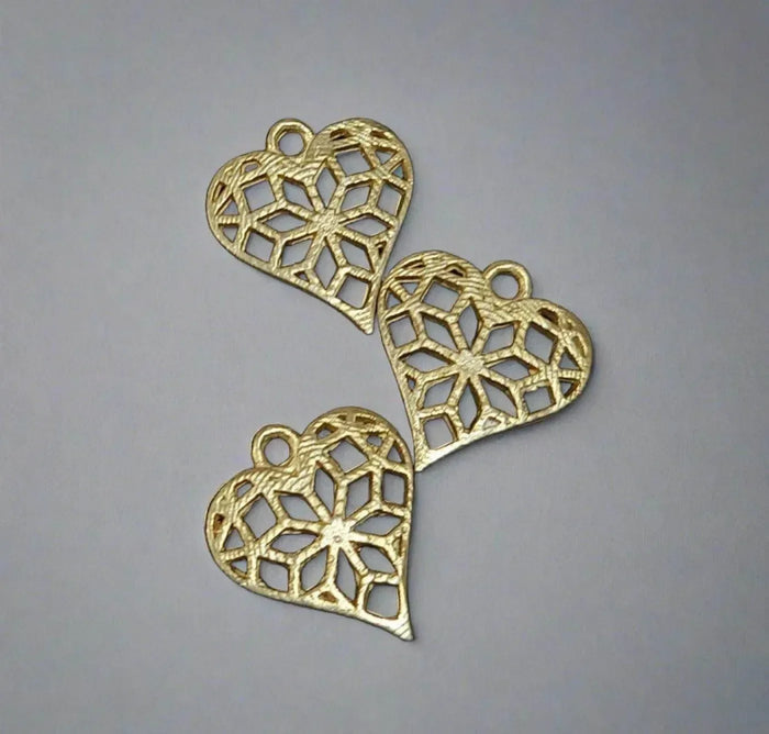 Gold heart charms with intricate filigree design for elegant jewelry making