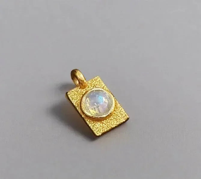 Gold pendant with moonstone, textured square design, elegant jewelry accessory
