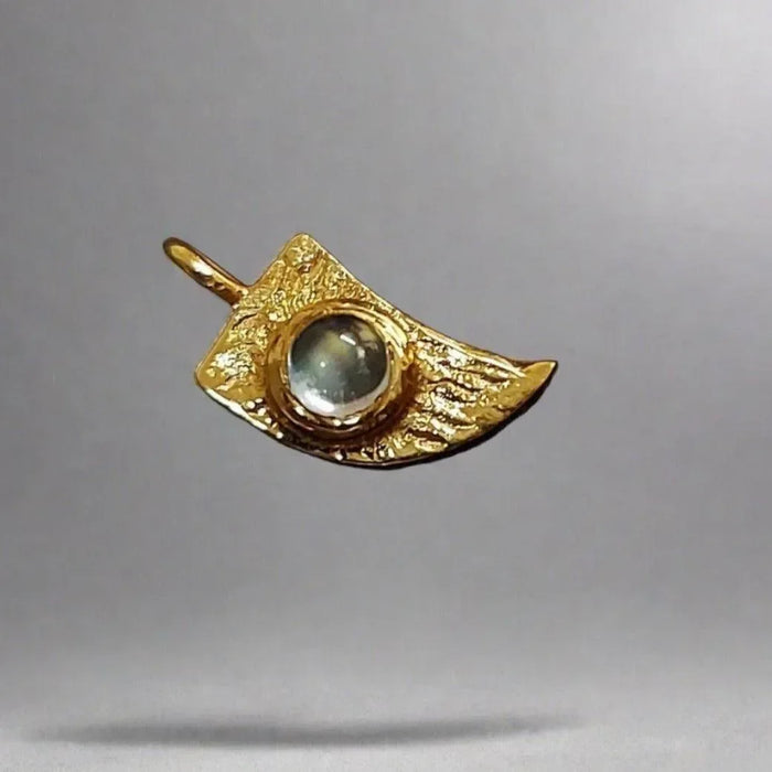 Gold pendant with textured wing design and central gemstone, elegant jewelry accessory