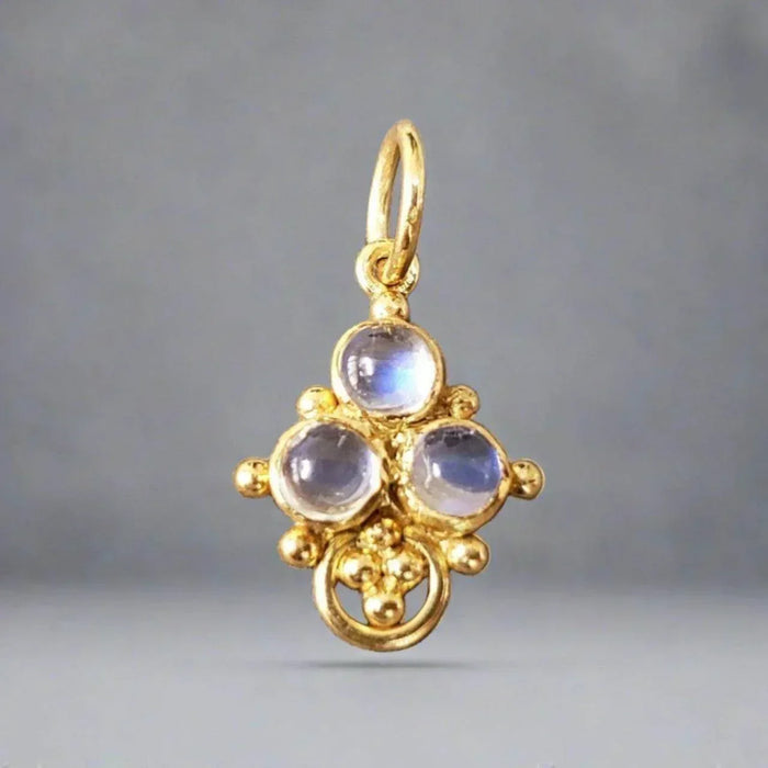 Elegant gold pendant with three moonstones, vintage-inspired design for luxury jewelry lovers