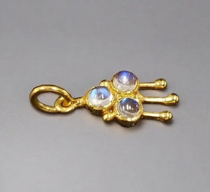 Gold charm with three moonstones, elegant jewelry accessory for necklaces or bracelets