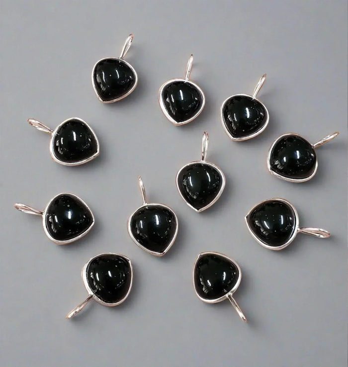 Elegant black onyx pendants in silver settings, perfect for luxury jewelry collections