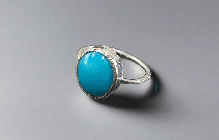 Elegant turquoise stone ring with textured silver band, perfect for sophisticated jewelry lovers