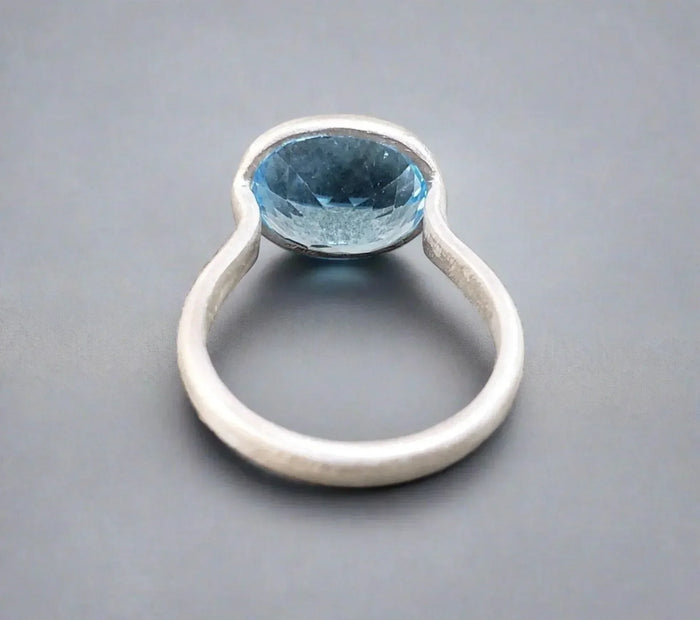 Elegant silver ring with oval blue gemstone, minimalist design for sophisticated jewelry lovers