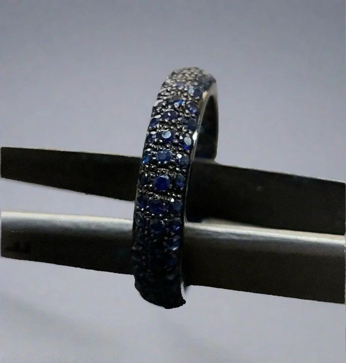 Elegant sapphire and diamond eternity ring, showcasing luxurious gemstone craftsmanship