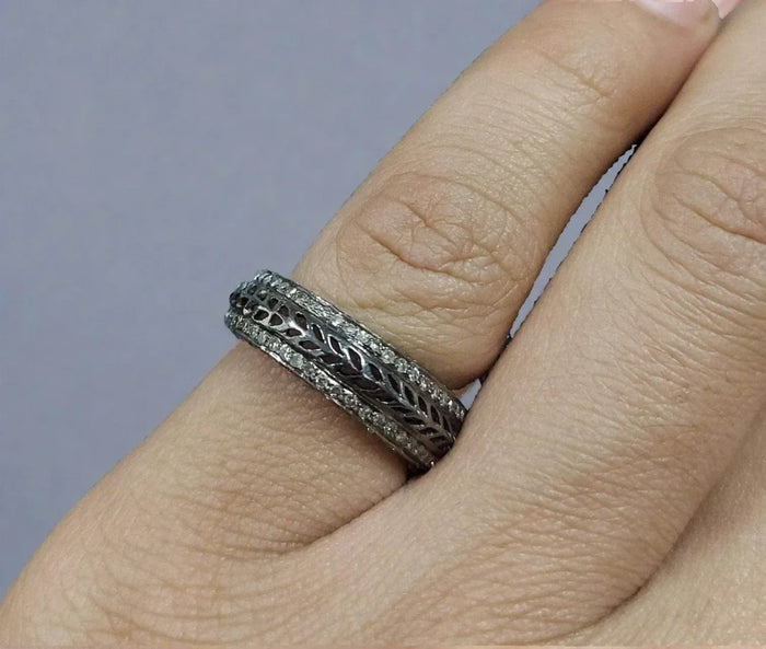 Elegant diamond-encrusted band with intricate leaf pattern, showcasing sophisticated jewelry design.