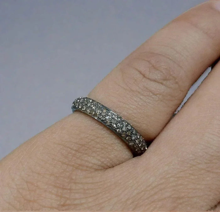 Elegant diamond eternity band ring on finger, sparkling gold & diamond jewelry for sophisticated style