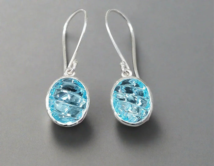Elegant blue topaz drop earrings in sterling silver, perfect for sophisticated jewelry lovers