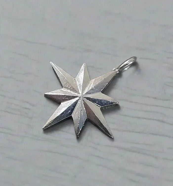Silver star pendant with textured facets, elegant jewelry accessory for necklaces