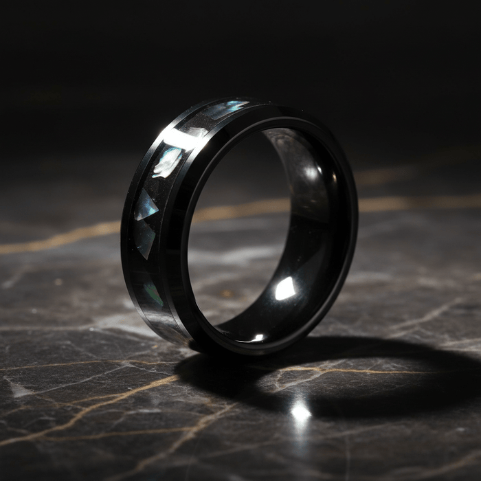 ABALONX — Luxury 3/4 angle on dark marble — men's tungsten wedding ring.